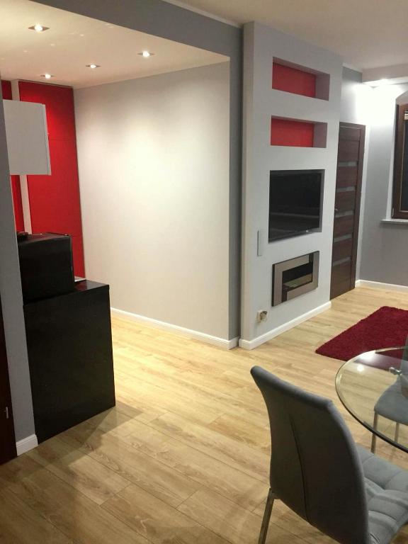 Televízia a/alebo spoločenská miestnosť v ubytovaní JAB Apartments Panoramika Business & Family