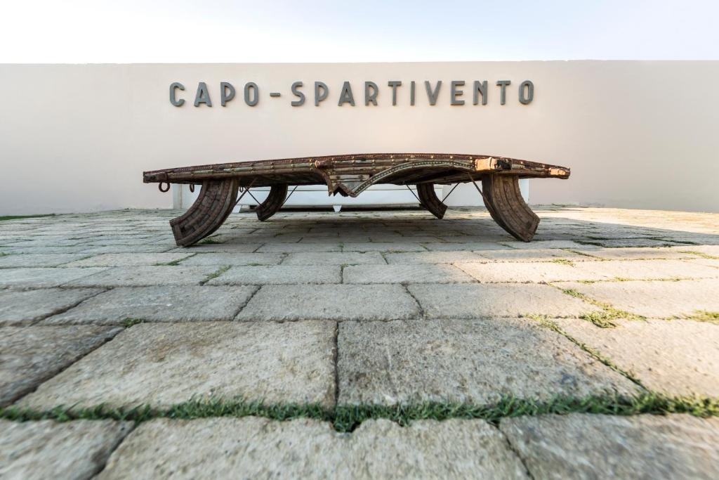 a bench sitting on top of a stone ground at Faro Capo Spartivento in Chia