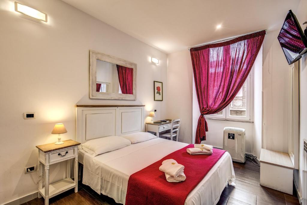 a bedroom with a bed with a red blanket at Magenta Collection Del Grande 51 in Rome
