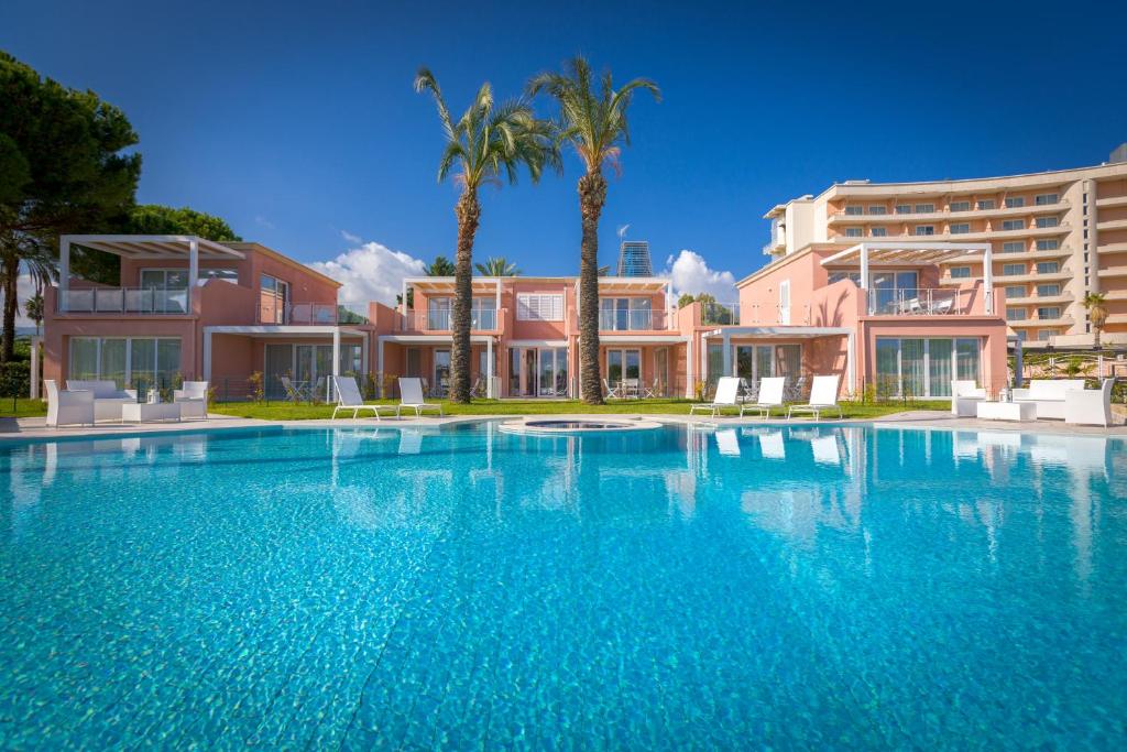 a large swimming pool in front of a building at Residence Delfino, Portorosa in Furnari