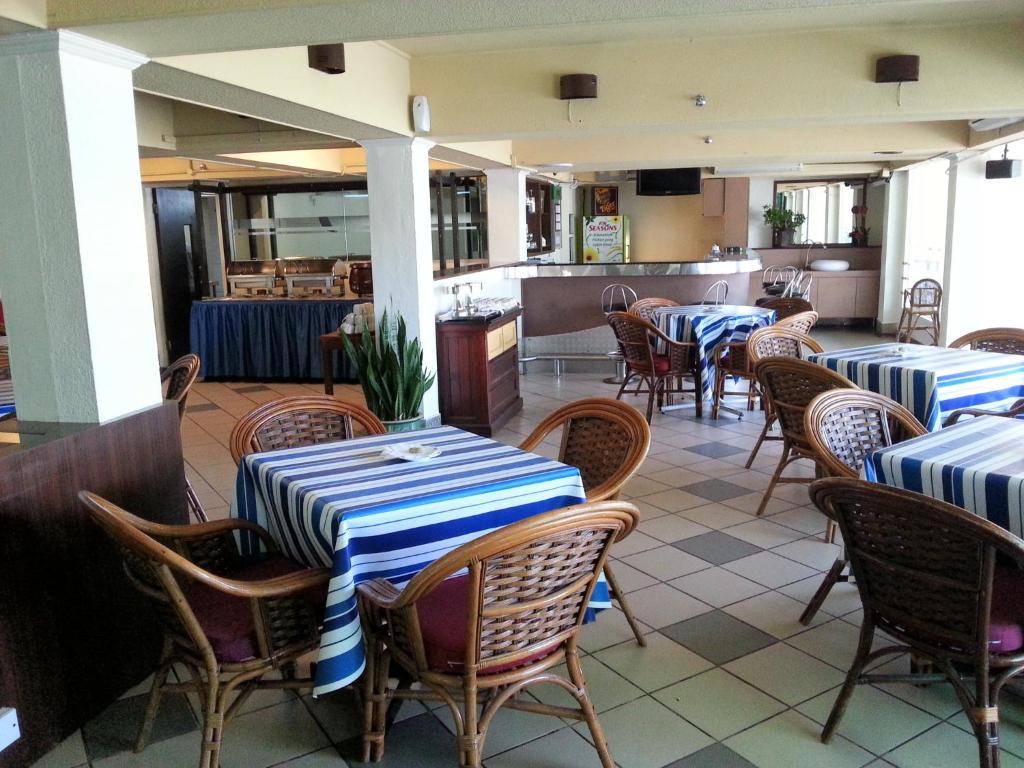 a restaurant with blue and white tables and chairs at Pacific Orient Hotel ( 凯富大酒店 ) in Miri