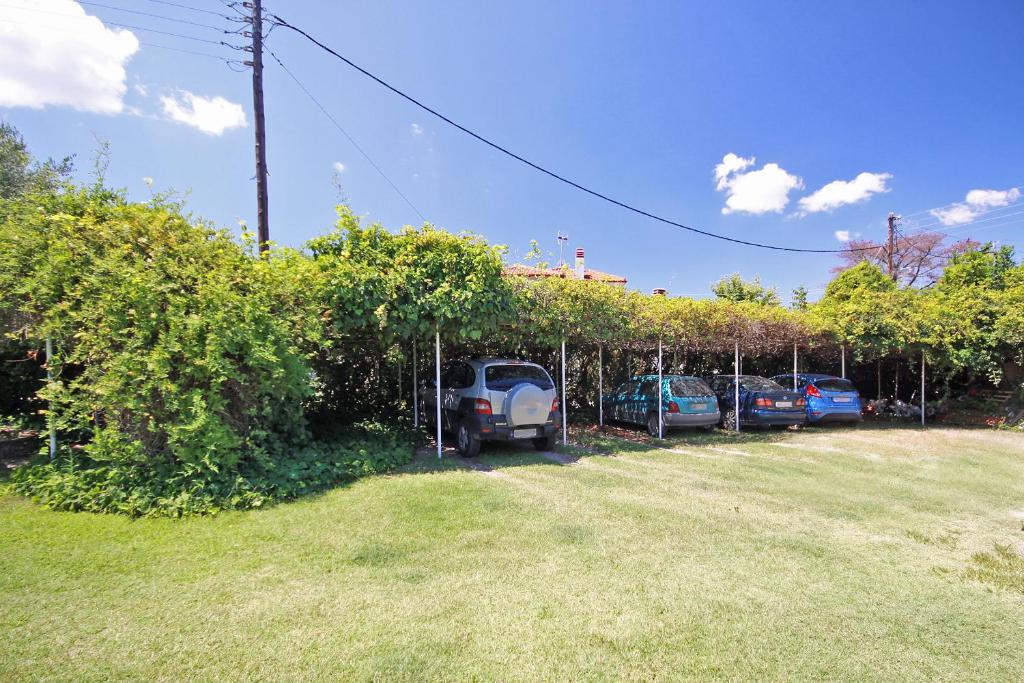 a group of cars parked in a parking lot at Villa Angela in Vourvourou
