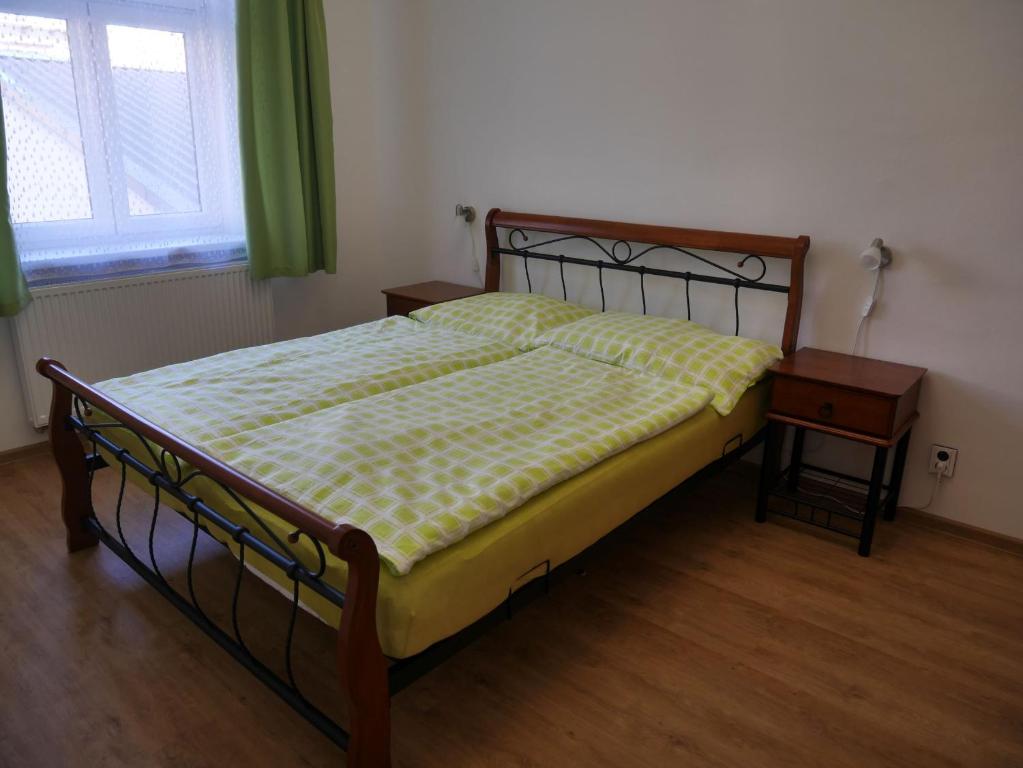 a bedroom with a bed and a table and a window at Moskevská 40 in Karlovy Vary