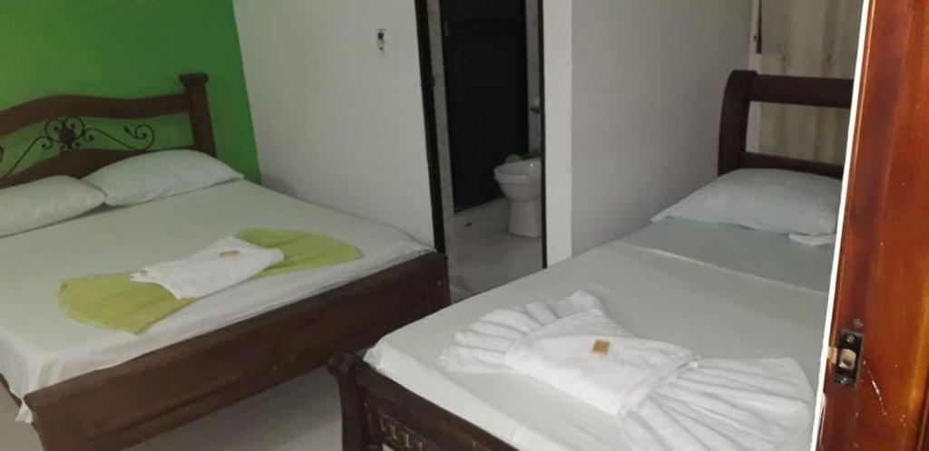 Postel nebo postele na pokoji v ubytování Hotel Mansión del Cesar