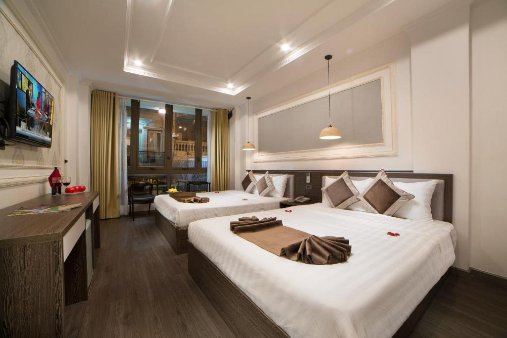 Postel nebo postele na pokoji v ubytování Galliot Central Hotel
