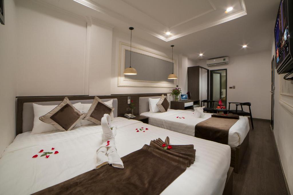 Postel nebo postele na pokoji v ubytování Galliot Central Hotel