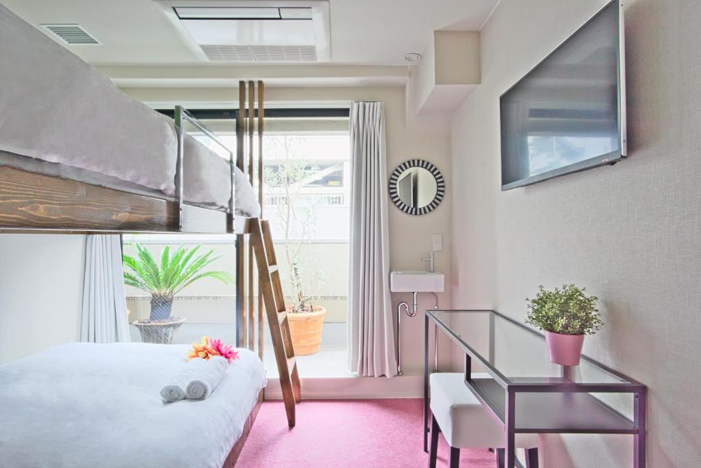 Postel nebo postele na pokoji v ubytování Feel Osaka Yu
