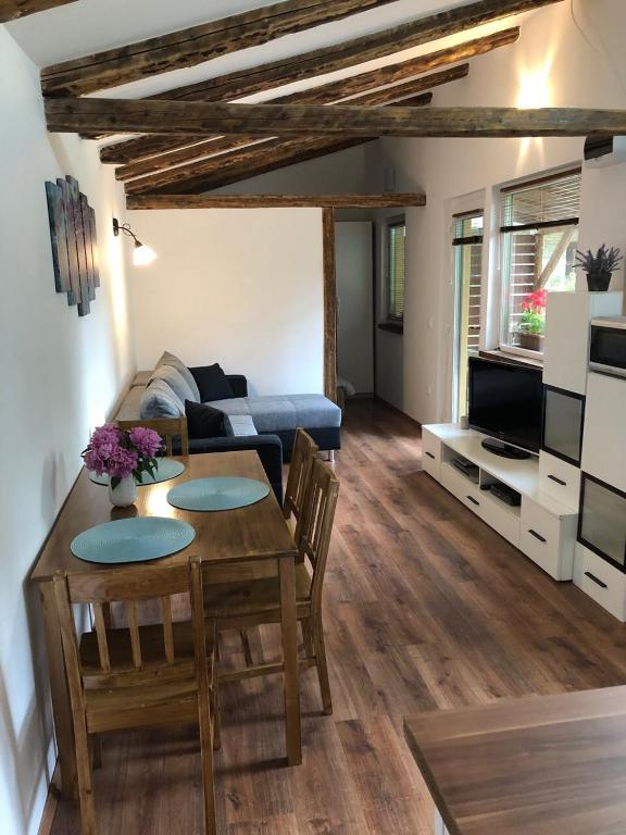 a living room with a table and a couch at Tulipán-Apartman in Eger