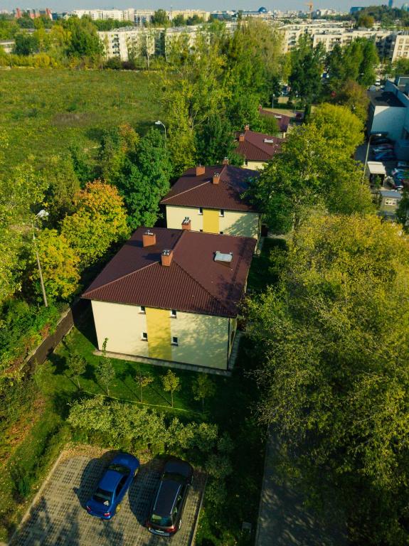 an overhead view of a house with two cars parked at L26 Łopuszańska in Warsaw