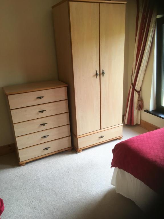 a bedroom with a dresser and a large cabinet at ocean view in Wexford