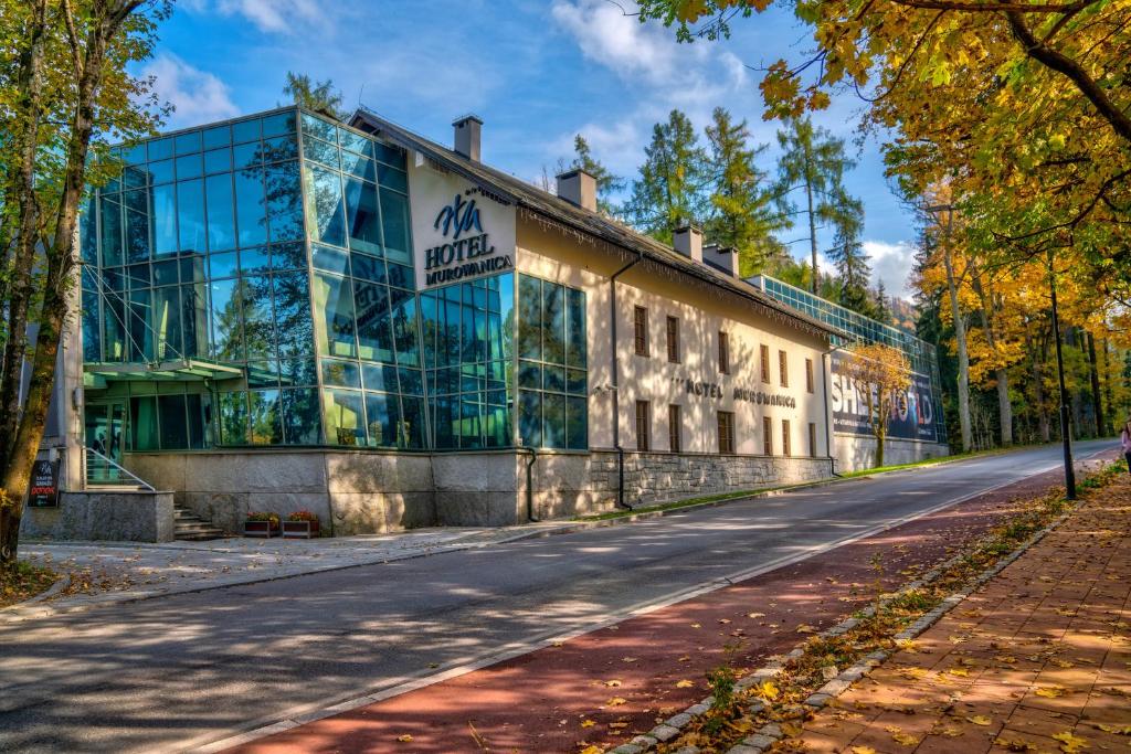 a building with a sign on the side of it at Hotel Murowanica in Zakopane