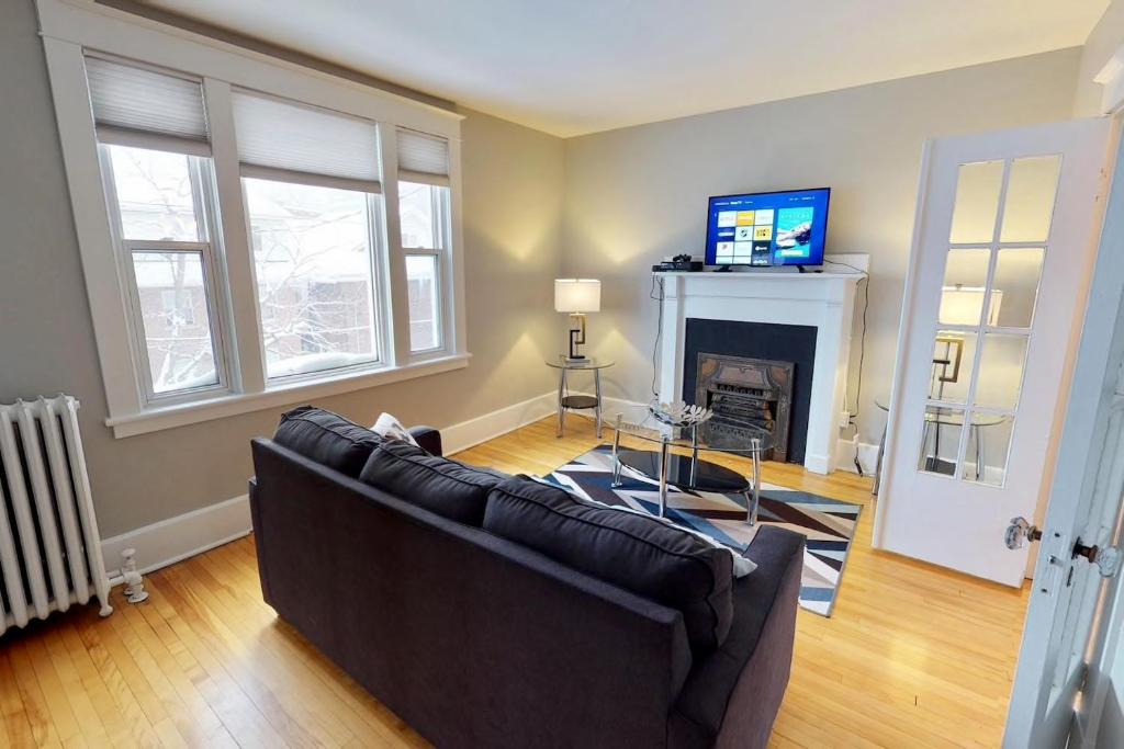 a living room with a couch and a fireplace at Bright, Clean, Private. In the Heart of Downtown! Parking, Wi-Fi and Netflix included in Ottawa