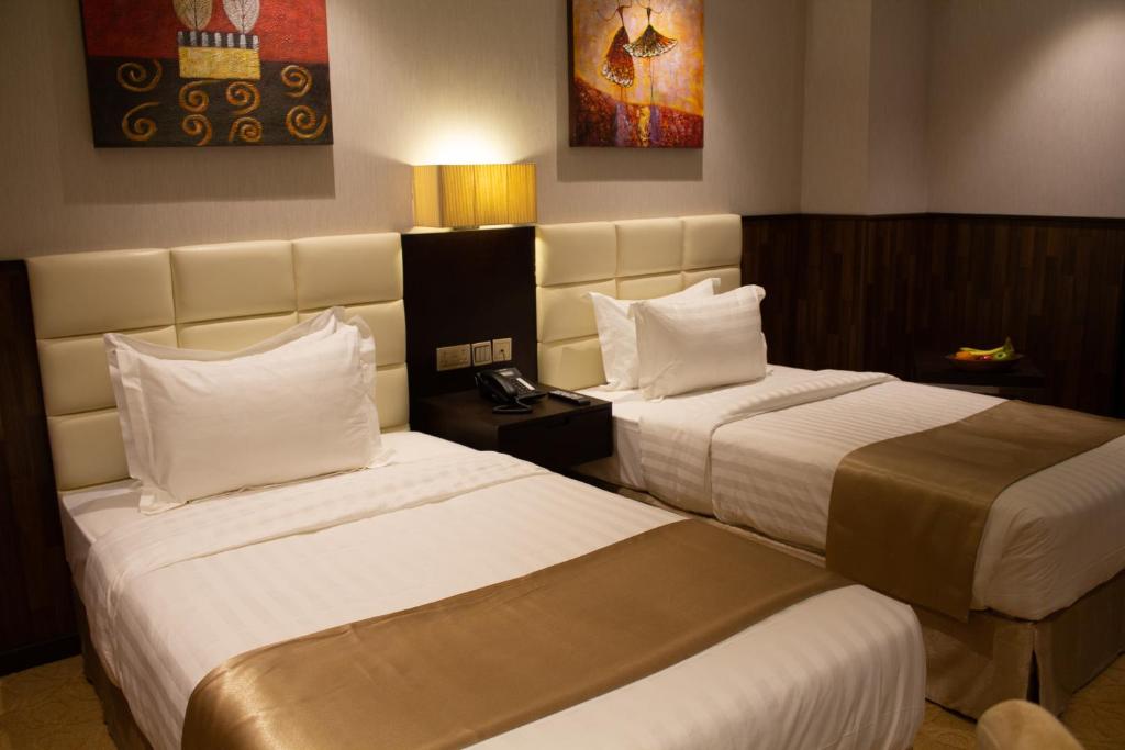 Postel nebo postele na pokoji v ubytování The Secure Inn Hotel Muscat