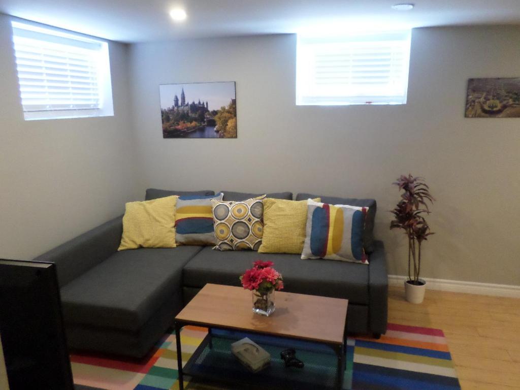 a living room with a couch and a coffee table at Fantastic and Modern Downtown 1-Bed Basement Apt., parking Wi-Fi and Netflix included in Ottawa