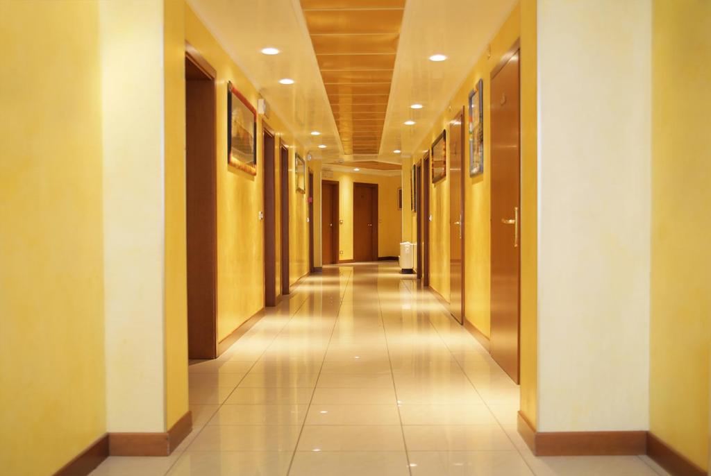 a hallway in a building with a long corridor at Hotel Nuova Aurora in Marghera