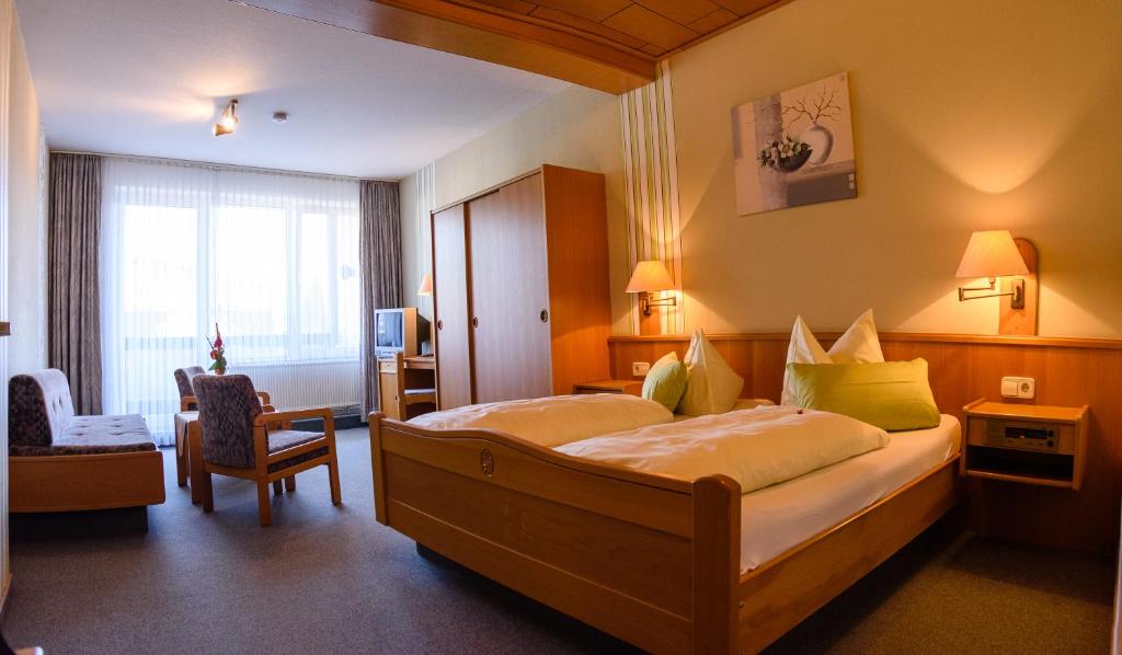 a hotel room with a large bed in a room at Landhotel Henkenhof Willingen in Willingen