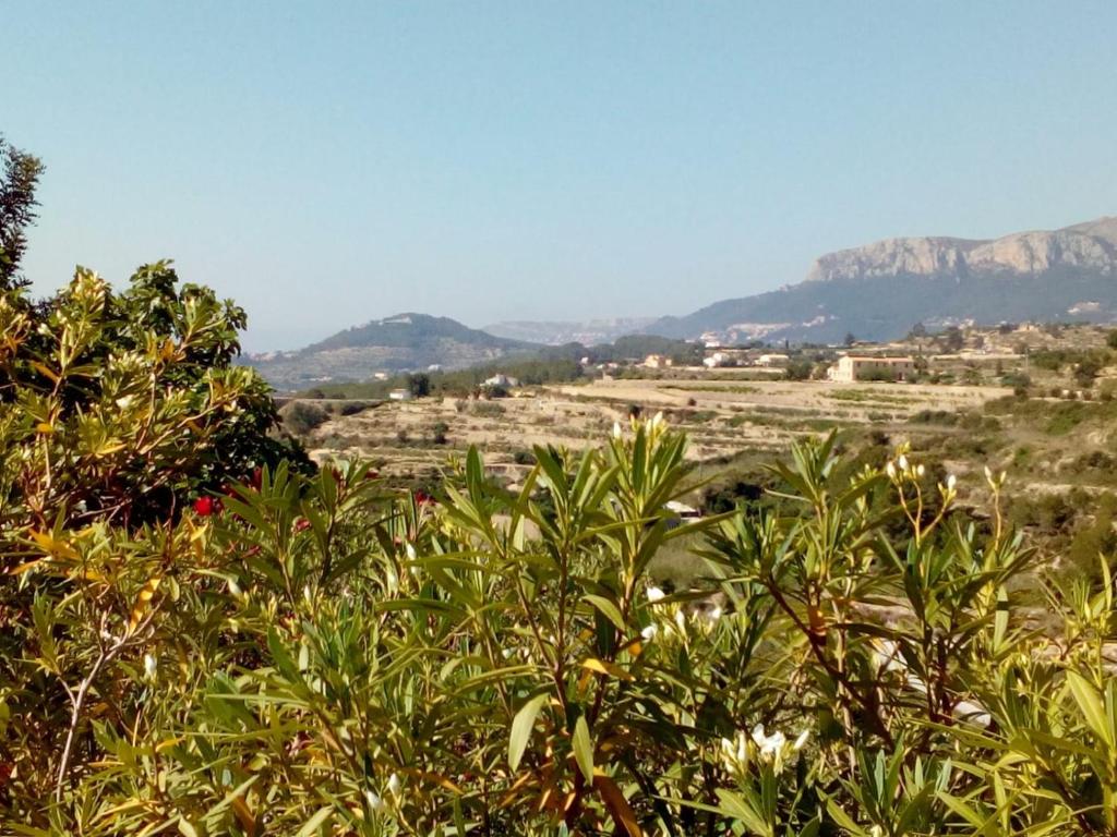a view of a field with mountains in the background at Beautiful Benissa Views in Benissa