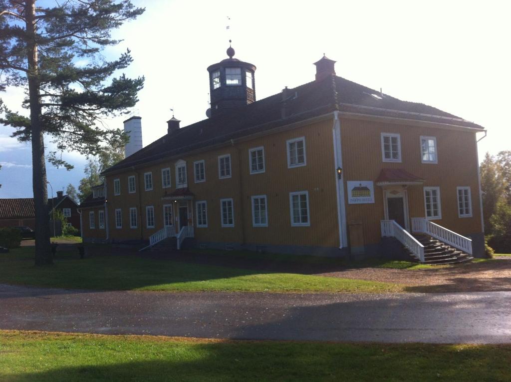 an old building with a clock tower on top of it at Insjöns Hotell in Insjön