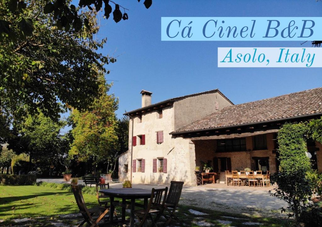 a house with a table and chairs in front of it at B&B Ca' Cinel Asolo in Asolo