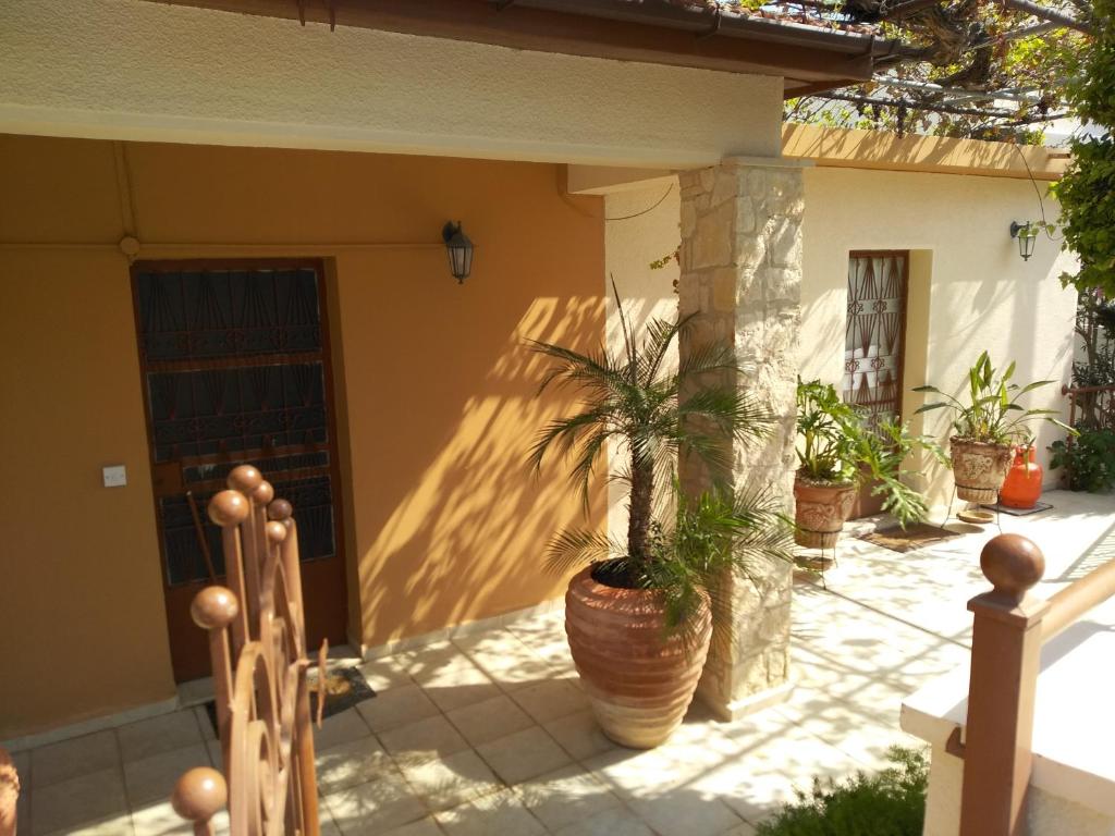 a porch with potted plants on a house at Patriko Village Home in Pissouri