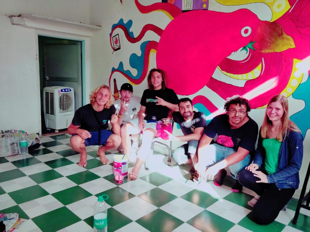 a group of people sitting in a room with a wall at Hoztel Jaipur in Jaipur