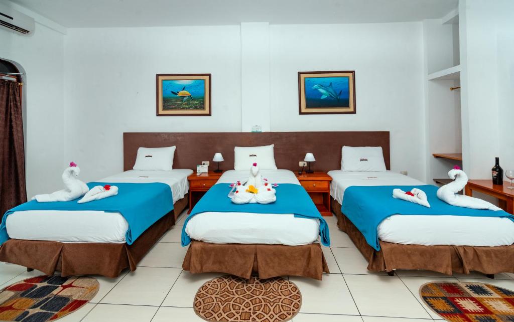 Postel nebo postele na pokoji v ubytování Hotel Coloma Galapagos