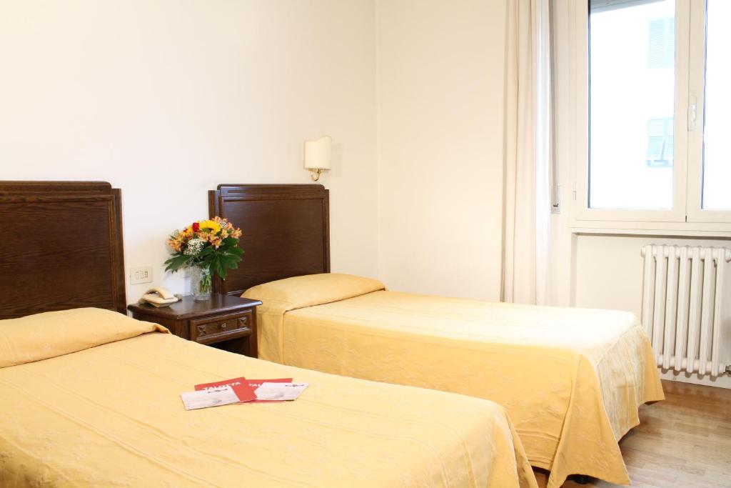 Postel nebo postele na pokoji v ubytování Hotel La Pace