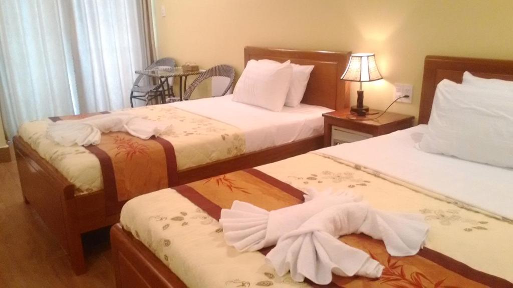 Giường trong phòng chung tại Tabii hotel