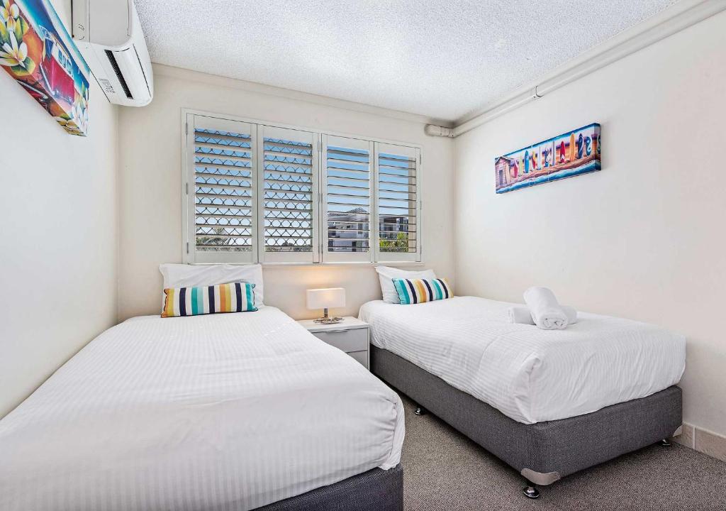 Postel nebo postele na pokoji v ubytování Sailport Mooloolaba Apartments