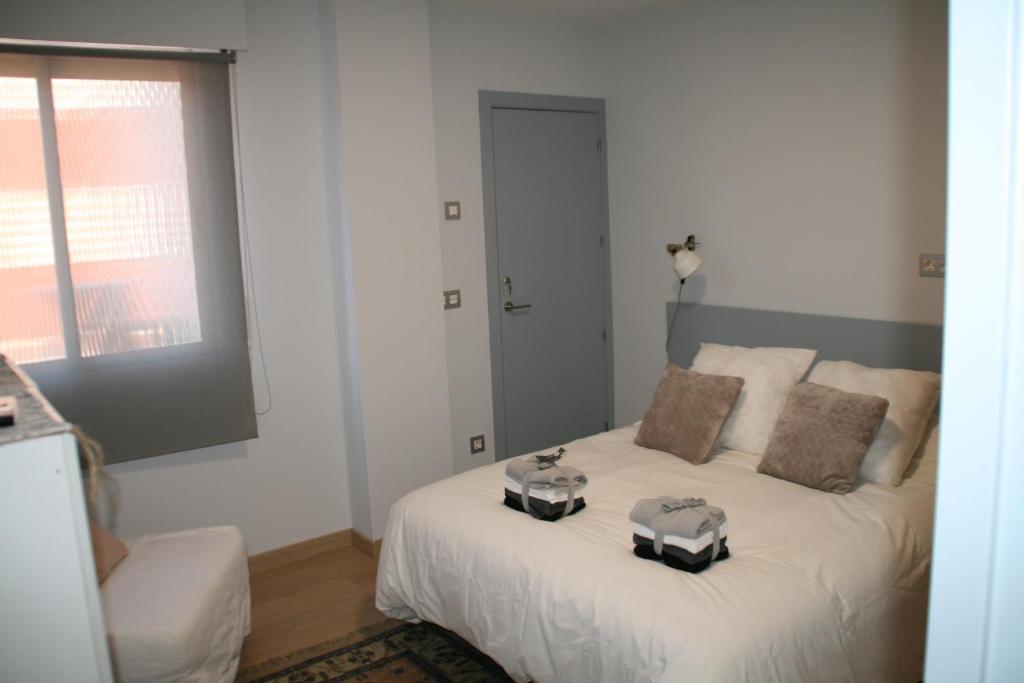 a bedroom with a bed with two boxes on it at Apartamento Alberche in Seville