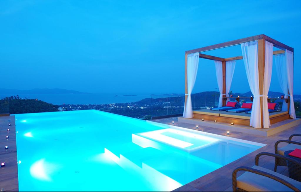 a house with a swimming pool at night at 9 Bedroom Sea Blue View Villa - 5 Star with Staff SDV080A-By Samui Dream Villas in Bophut 