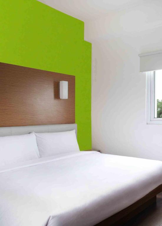 Postel nebo postele na pokoji v ubytování Amaris Hotel Pratama Nusa Dua