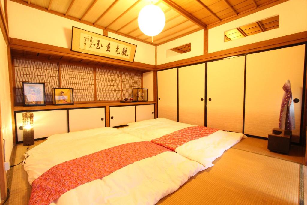 um quarto com uma cama grande num quarto em Fuji Sakura House em Fujikawaguchiko