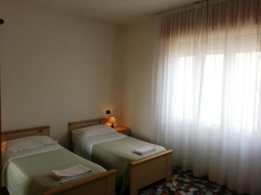 Postel nebo postele na pokoji v ubytování Hotel Clodia