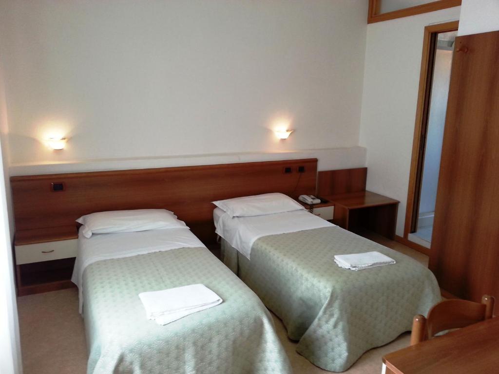 Postel nebo postele na pokoji v ubytování Hotel Clodia