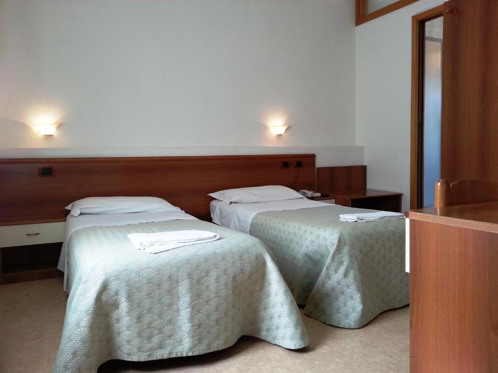Postel nebo postele na pokoji v ubytování Hotel Clodia