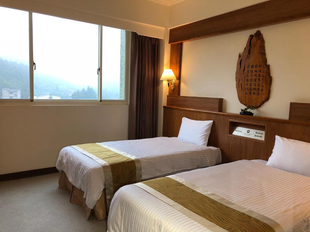 Postel nebo postele na pokoji v ubytování Ginkgo Hotel
