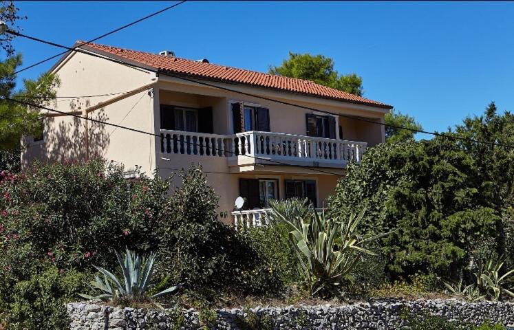 a large house with a balcony on top of it at Guesthouse Antonija in Veli Lošinj