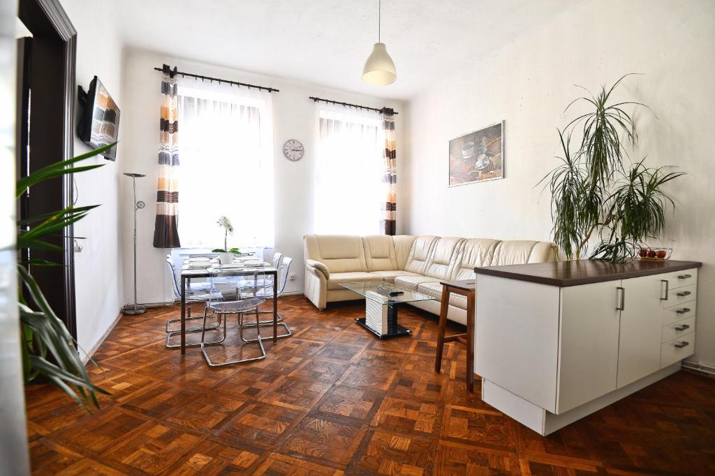 a living room with a couch and a table at Spacious cozy apartments in centre in Prague