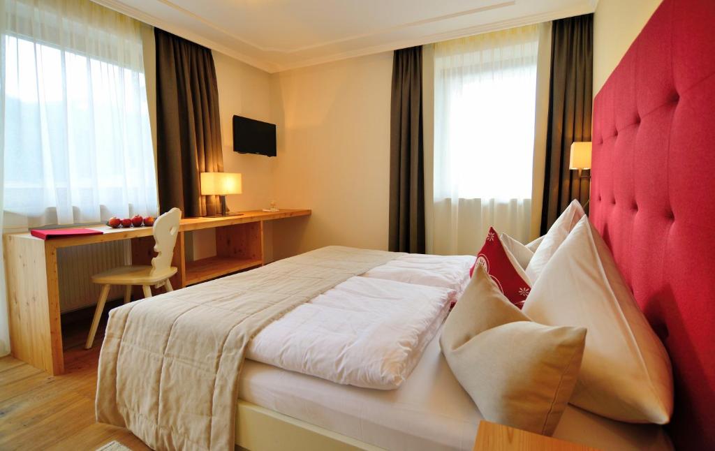 Postel nebo postele na pokoji v ubytování Hotel Brunnerhof