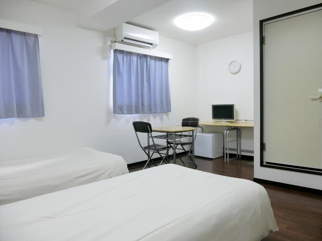 Postel nebo postele na pokoji v ubytování Hotel Chuo Oasis