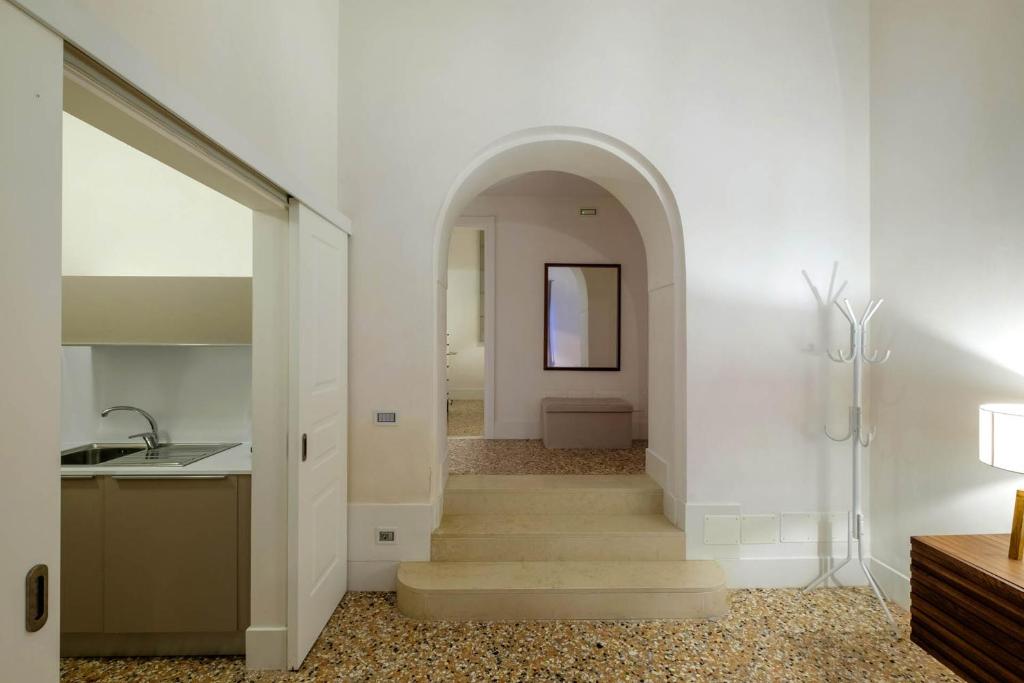 a hallway with stairs and an archway in a house at Ca' Molin Cuoridoro - Guarana in Venice