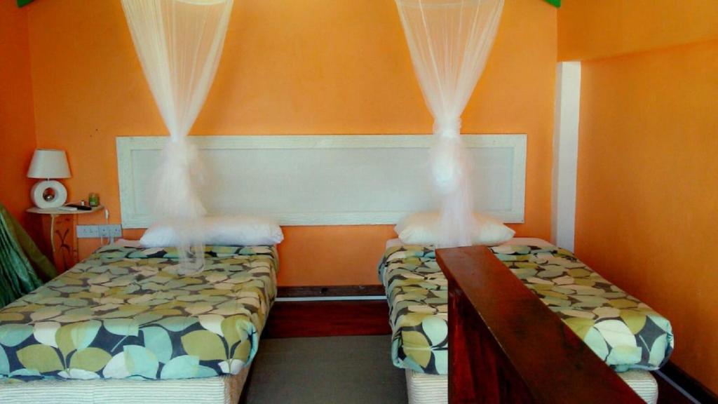 Postel nebo postele na pokoji v ubytování Villa Des Pitons
