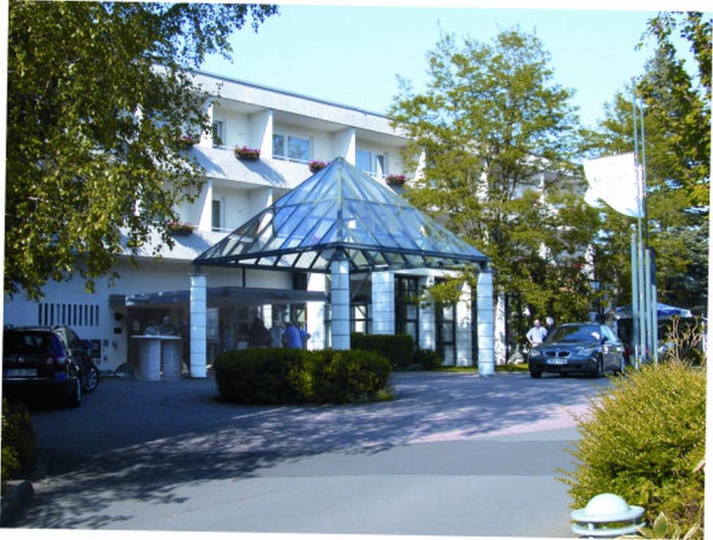 a building with a gazebo in a parking lot at Hotel Gersfelder Hof in Gersfeld