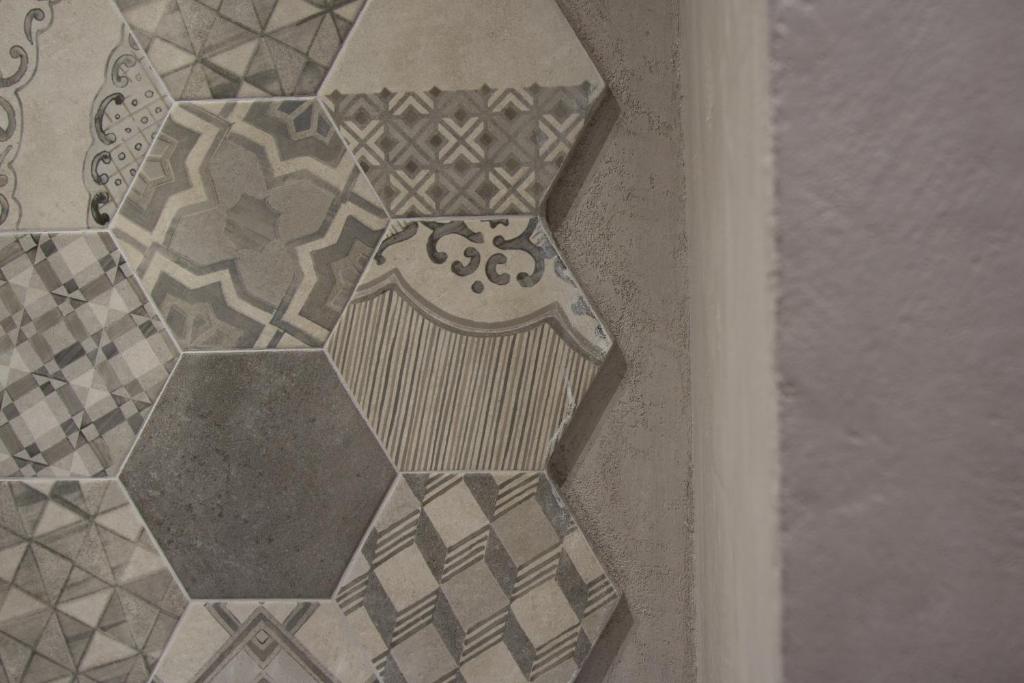a picture of a tile floor with a bench at Panoramica dei Templi B&B in Agrigento