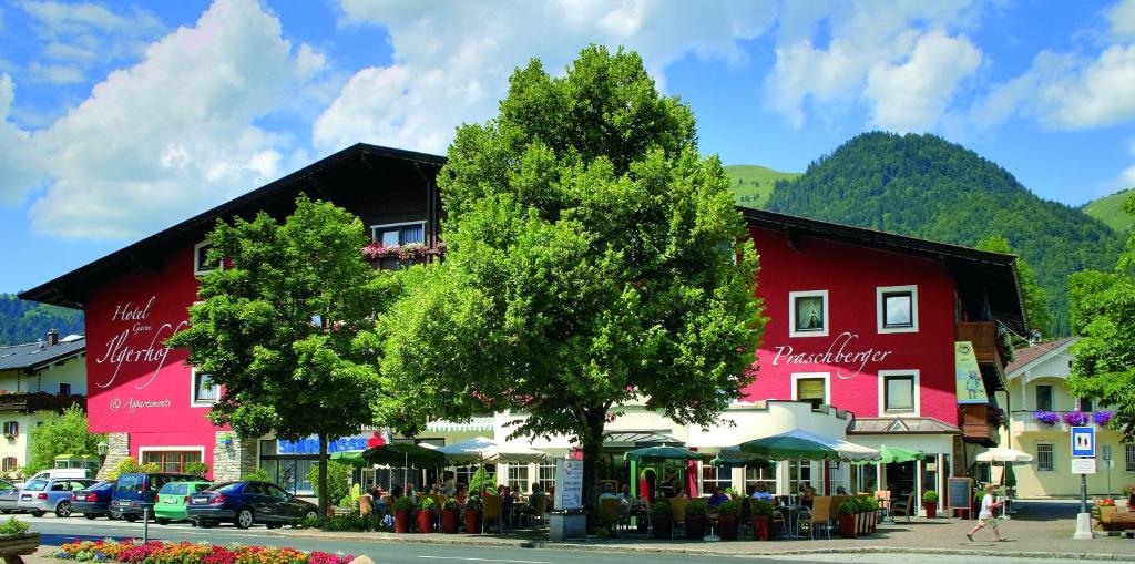 a street in a town with a red building at Hotel Garni & Appartements Ilgerhof in Walchsee
