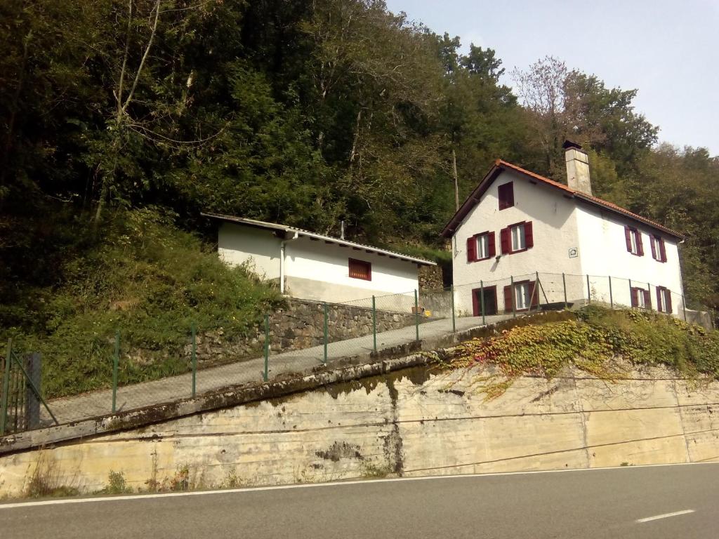 a white house on the side of a hill at Casa Manuelena in Valcarlos