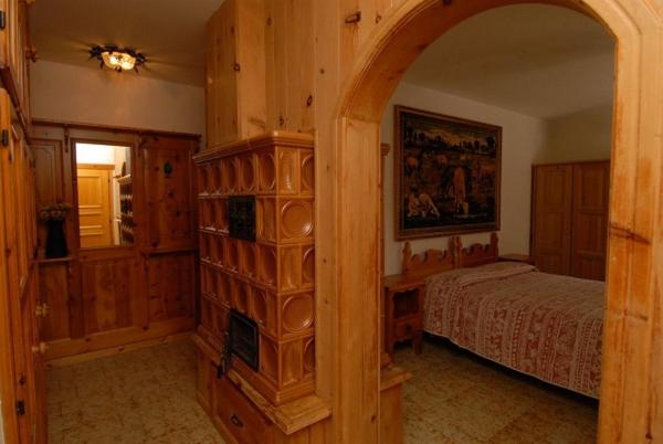 a bedroom with a bed and an archway in a room at Baita Guana in Livigno