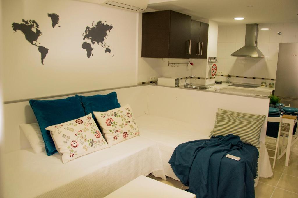 a kitchen with a couch with two pillows on it at Apartamento Botavara in Málaga