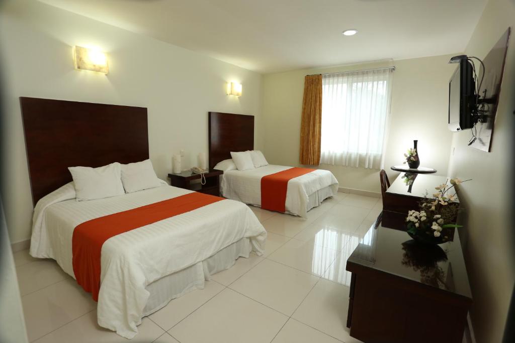 Postel nebo postele na pokoji v ubytování Hotel Marel